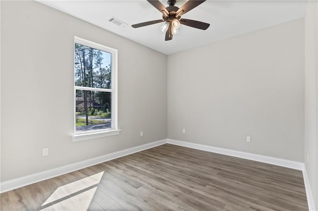 empty room with ceiling fan and hardwood / wood-style floors