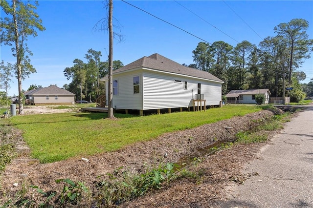 view of property exterior featuring a lawn