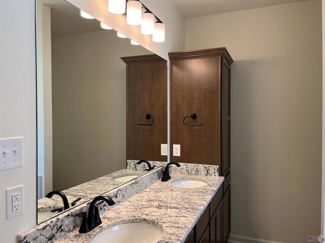 bathroom featuring dual vanity