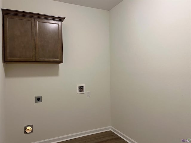 washroom with hookup for a washing machine, electric dryer hookup, dark wood-type flooring, and cabinets