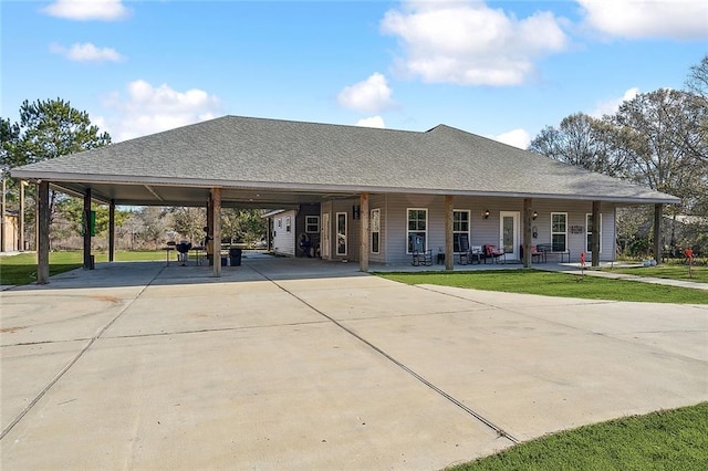 view of front of property featuring a front yard, a carport, and a porch