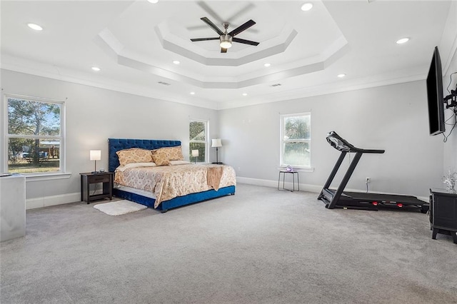 bedroom featuring a raised ceiling, ceiling fan, ornamental molding, and carpet floors