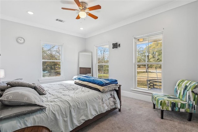 bedroom with carpet, ceiling fan, and crown molding