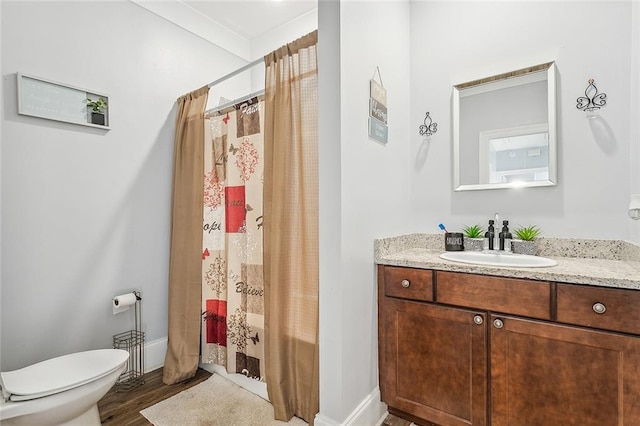 full bathroom featuring hardwood / wood-style flooring, shower / bath combination with curtain, vanity, and toilet