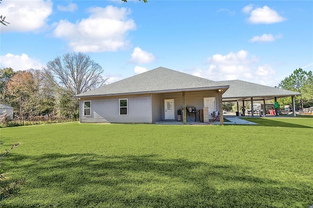 rear view of property featuring a lawn and a patio