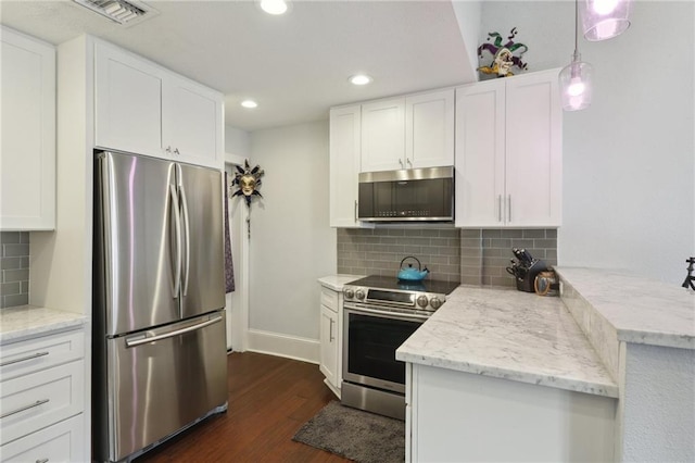 kitchen featuring stainless steel appliances, tasteful backsplash, dark hardwood / wood-style floors, and kitchen peninsula