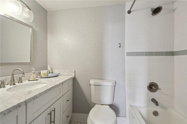 full bathroom featuring large vanity, toilet, and tiled shower / bath combo