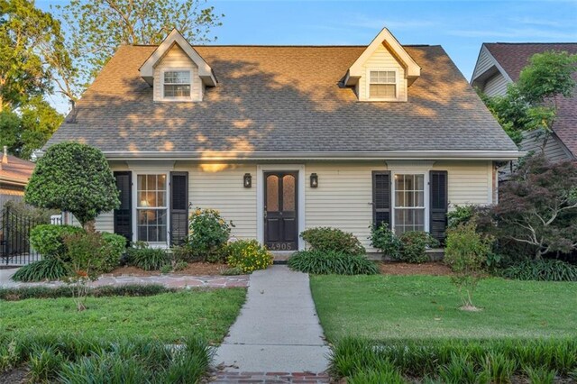 new england style home with a front yard