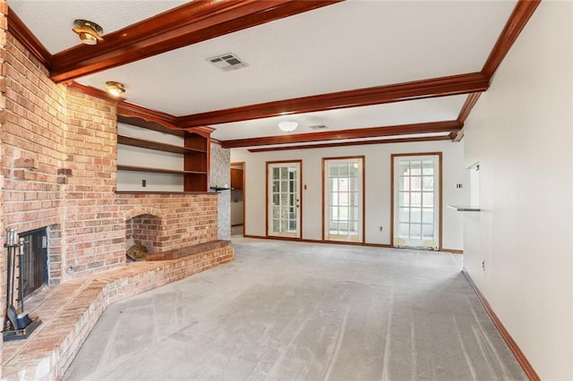 unfurnished living room featuring beamed ceiling, light colored carpet, crown molding, and a brick fireplace