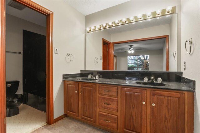 bathroom featuring ceiling fan, toilet, and vanity