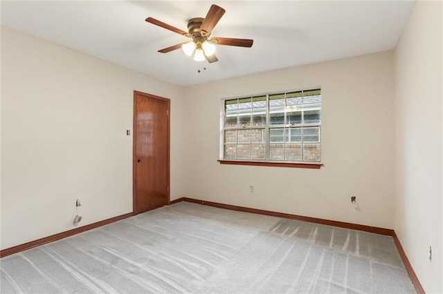 unfurnished room with ceiling fan and light carpet