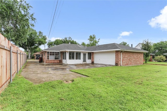 back of house featuring a yard and a garage