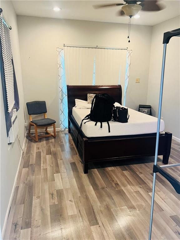 bedroom with ceiling fan and hardwood / wood-style flooring