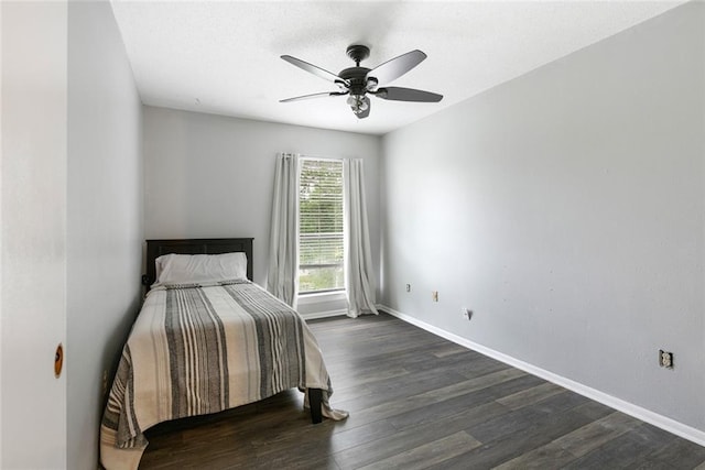 bedroom with ceiling fan and dark hardwood / wood-style flooring