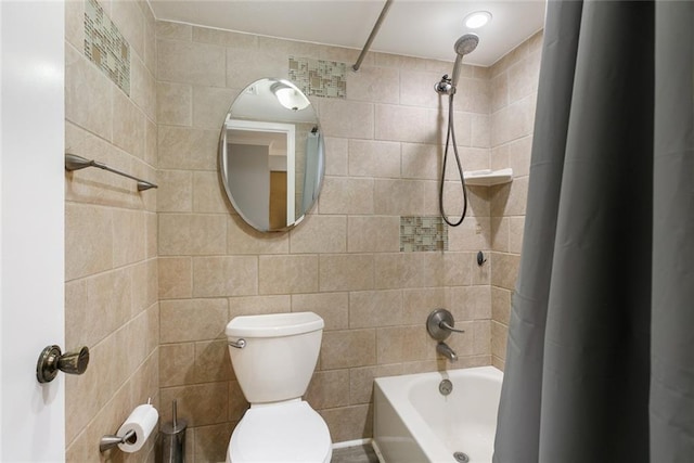 bathroom with shower / bath combination with curtain, toilet, and tile walls