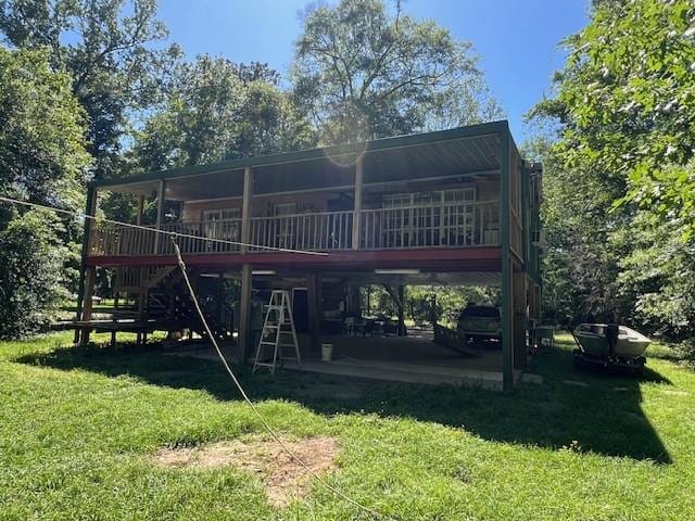 rear view of property with a deck and a lawn