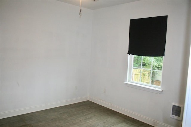 unfurnished room featuring dark hardwood / wood-style flooring