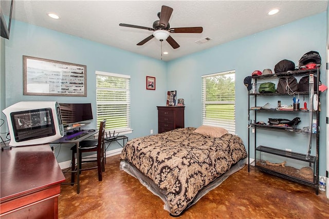 bedroom featuring ceiling fan and concrete floors