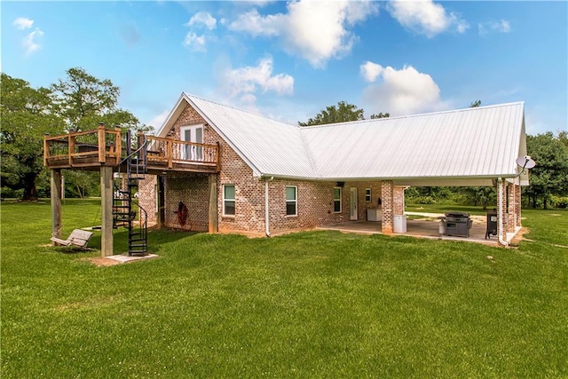 back of house featuring a deck, a lawn, and a patio