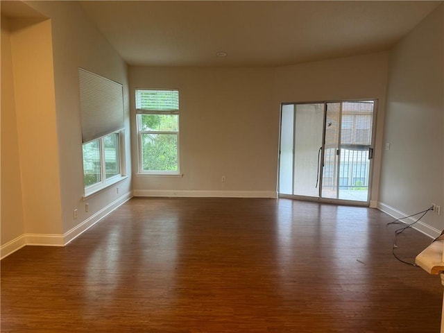 empty room featuring dark hardwood / wood-style flooring