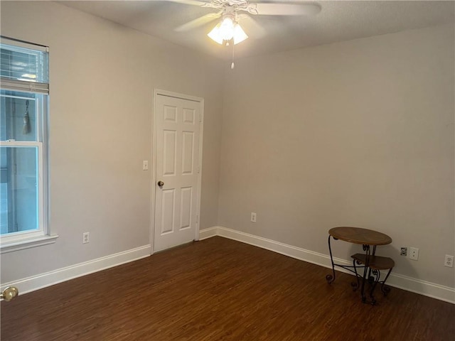 unfurnished room featuring dark hardwood / wood-style floors and ceiling fan