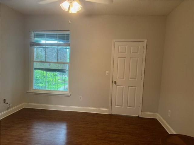 unfurnished room with ceiling fan and dark wood-type flooring