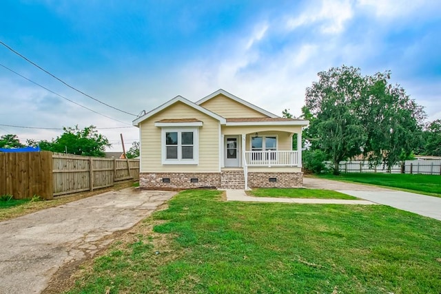 view of front of house with covered porch and a front yard