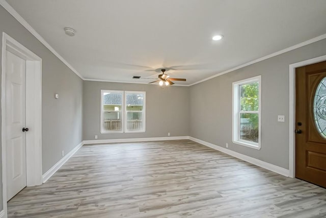 foyer with hardwood / wood-style flooring, ornamental molding, and ceiling fan