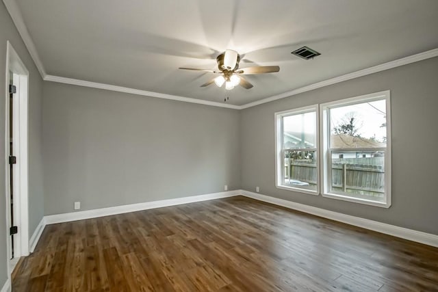 spare room featuring dark hardwood / wood-style floors, ceiling fan, and crown molding