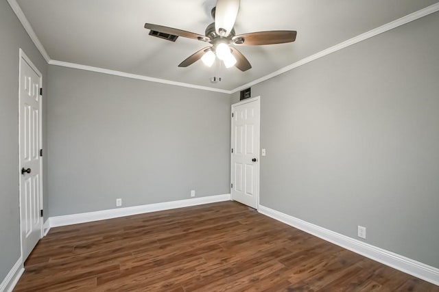 empty room with dark hardwood / wood-style flooring, ornamental molding, and ceiling fan