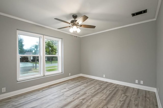 spare room with wood-type flooring, ceiling fan, and crown molding