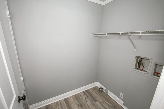 laundry area featuring crown molding, hardwood / wood-style flooring, and hookup for a washing machine