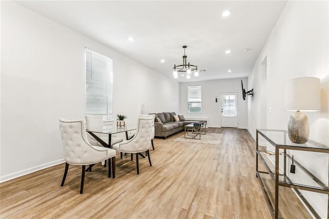 interior space with a chandelier and light hardwood / wood-style flooring