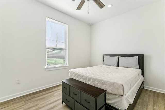 bedroom with ceiling fan and wood-type flooring