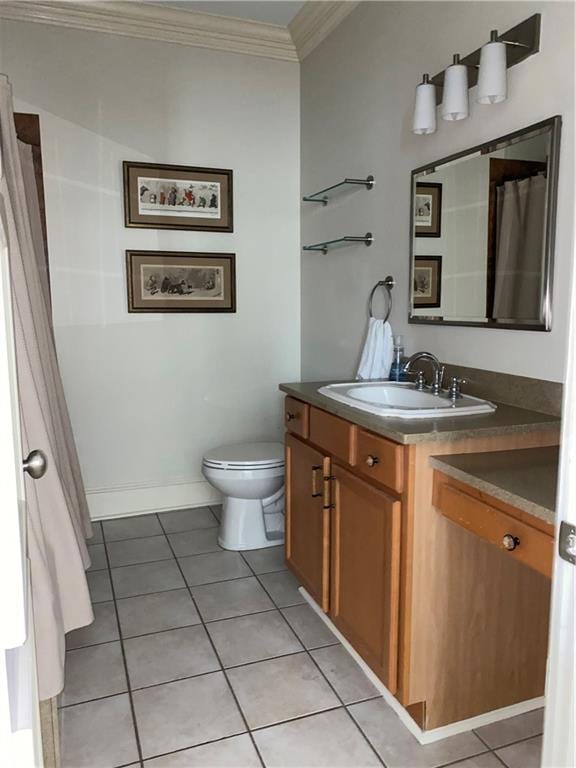 bathroom featuring tile patterned flooring, toilet, vanity, and ornamental molding