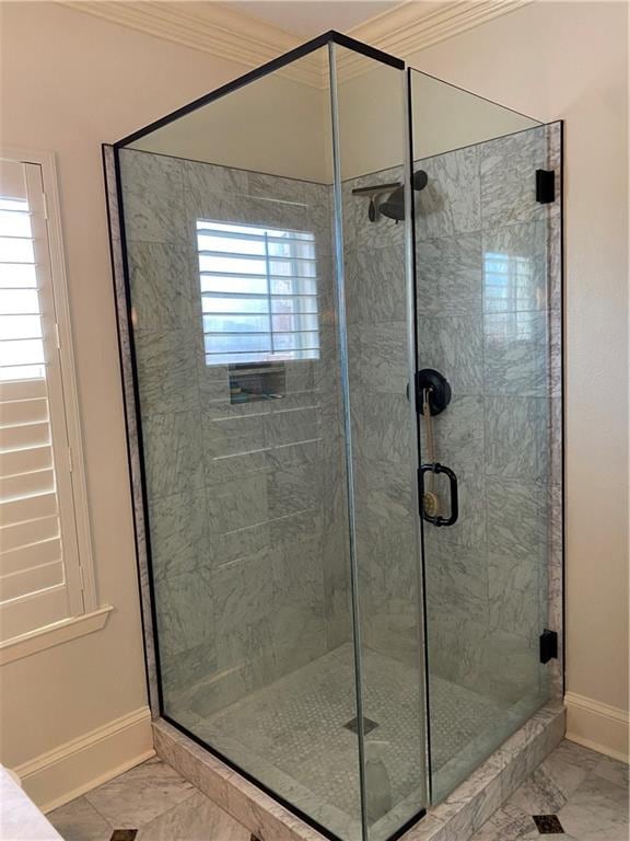 bathroom with tile patterned floors, a shower with door, and ornamental molding