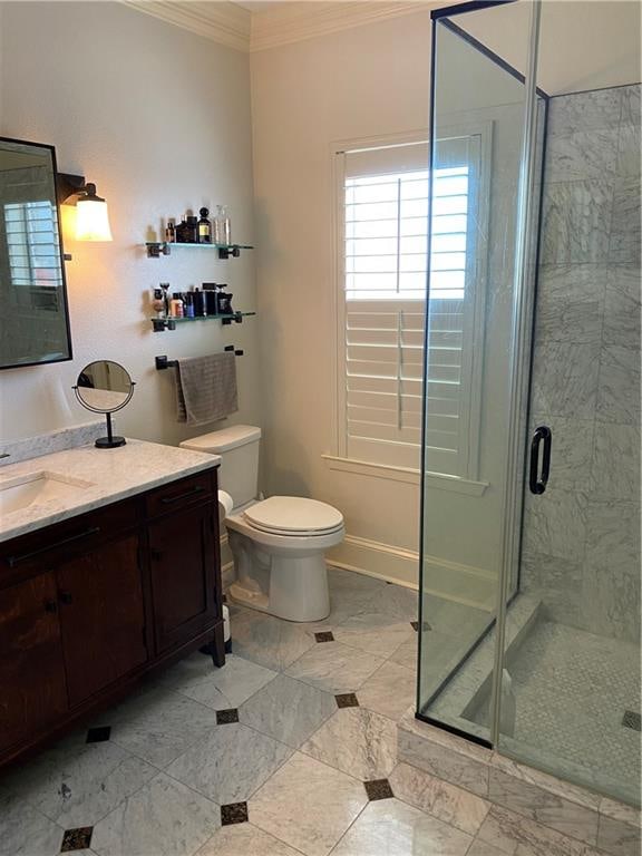 bathroom featuring an enclosed shower, crown molding, toilet, tile patterned floors, and vanity