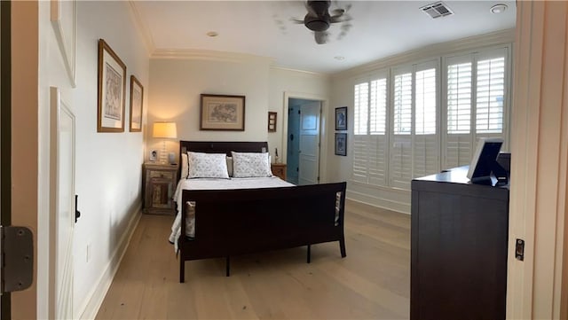 bedroom with ornamental molding, ceiling fan, and hardwood / wood-style floors