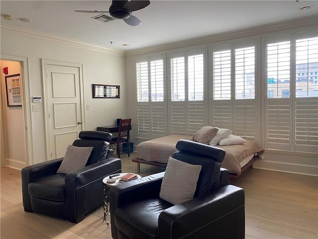 interior space featuring light wood-type flooring, ceiling fan, and ornamental molding