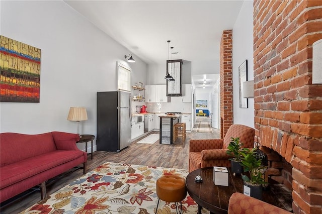 living room featuring hardwood / wood-style flooring and brick wall