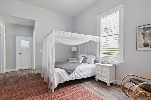 bedroom with dark hardwood / wood-style flooring