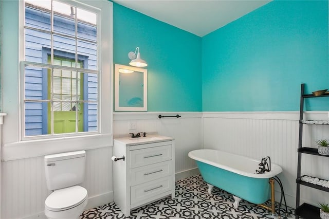 bathroom with a bath, tile flooring, large vanity, and toilet