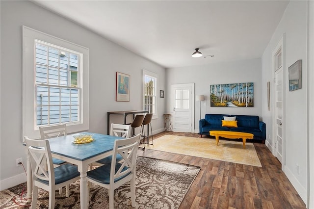 dining room with a wealth of natural light and hardwood / wood-style floors