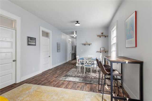 dining area featuring dark wood-type flooring