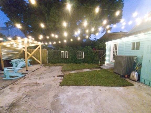 yard at night with a patio