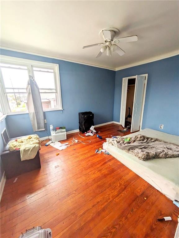 bedroom featuring crown molding, hardwood / wood-style floors, and ceiling fan