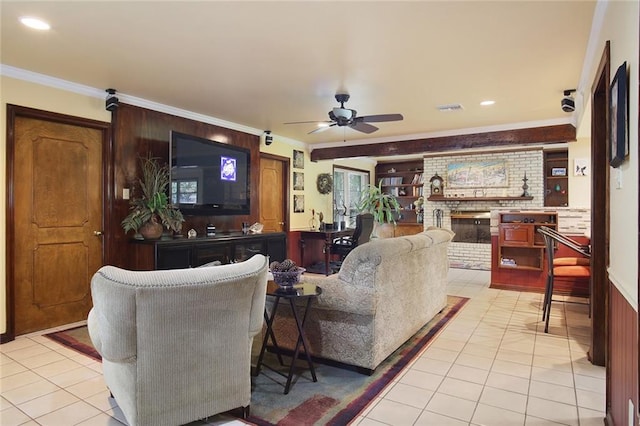 living room with a fireplace, ceiling fan, crown molding, and light tile patterned flooring