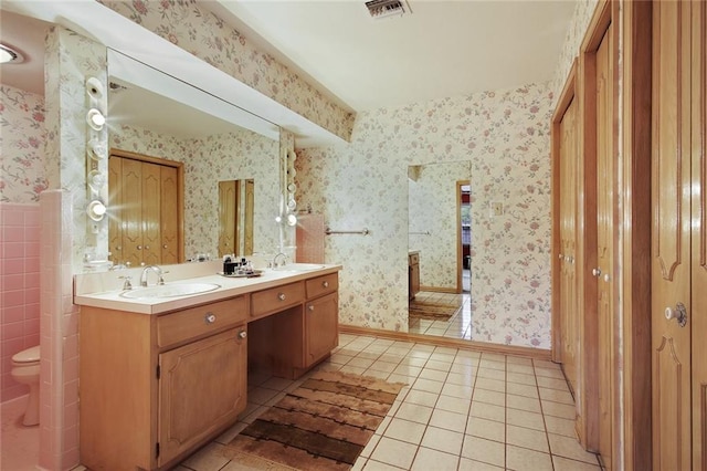 bathroom with tile patterned floors, vanity, and toilet