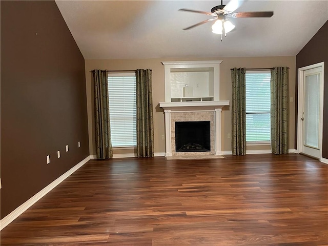 unfurnished living room featuring lofted ceiling, dark hardwood / wood-style floors, plenty of natural light, and ceiling fan