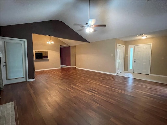 unfurnished living room with vaulted ceiling, hardwood / wood-style flooring, and ceiling fan with notable chandelier